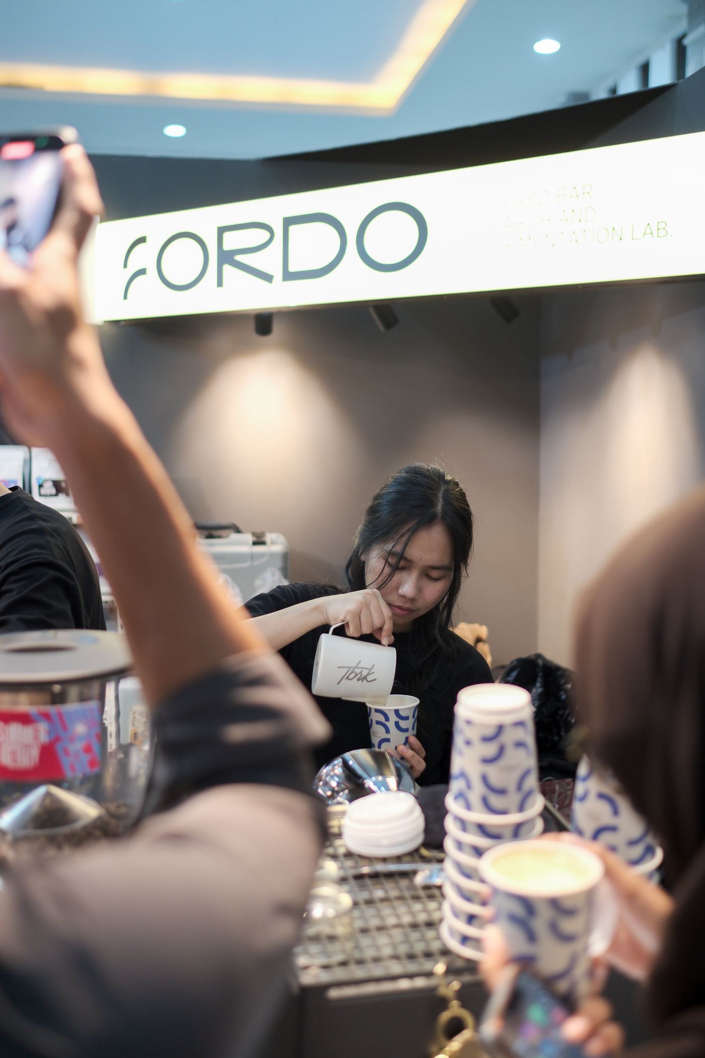 Barista steaming milk at the Fordo espresso bar